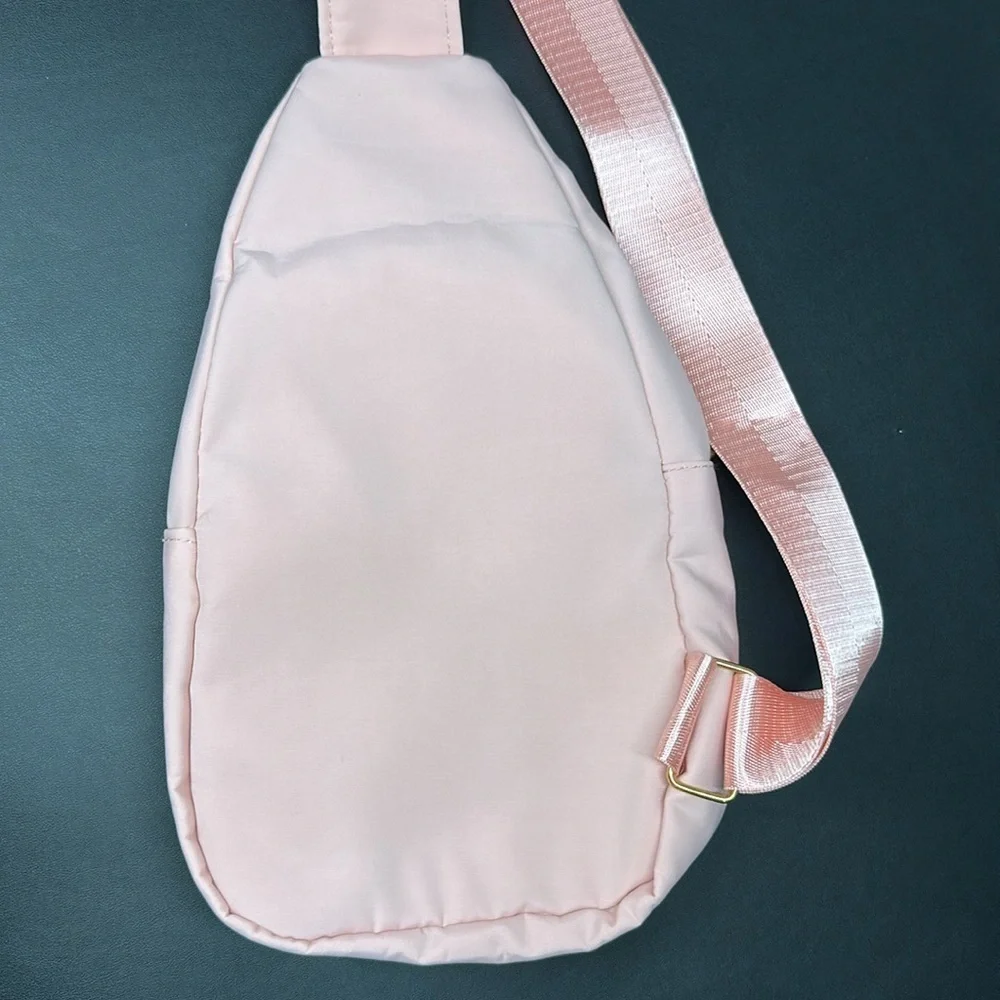 Pink Cross Body Backpack with gold zipper pockets